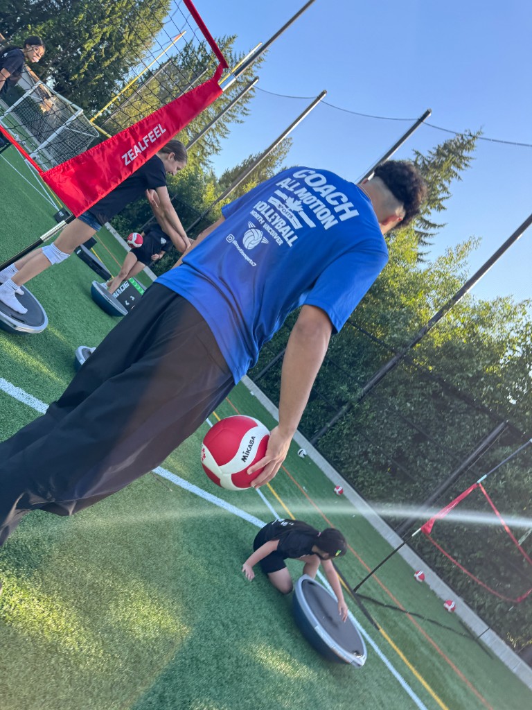 All Motion Sports coach leading outdoor summer volleyball drill