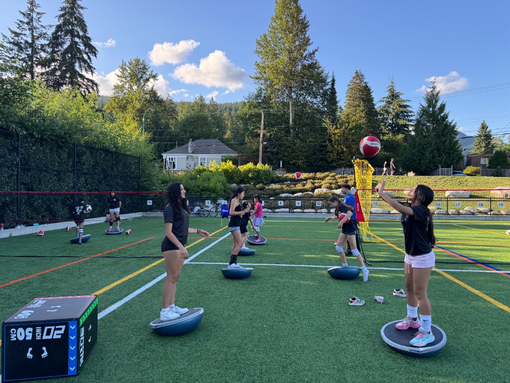 Summer volleyball practice on outdoor turf with Bosu ball drills