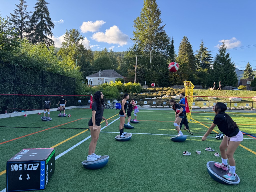 Athletes practicing balance drills on Bosu balls during summer training