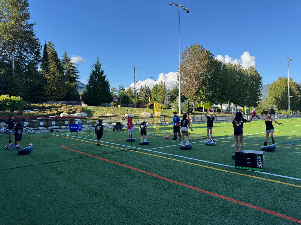 Youth athletes training on outdoor turf during Summer 2026 volleyball program